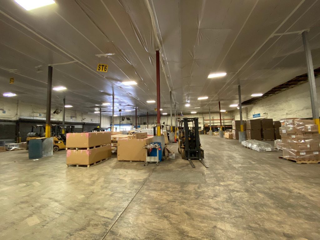 A warehouse filled with boxes and carts of goods.