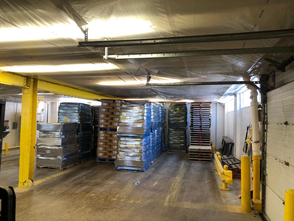 A warehouse filled with boxes and pallets of goods.