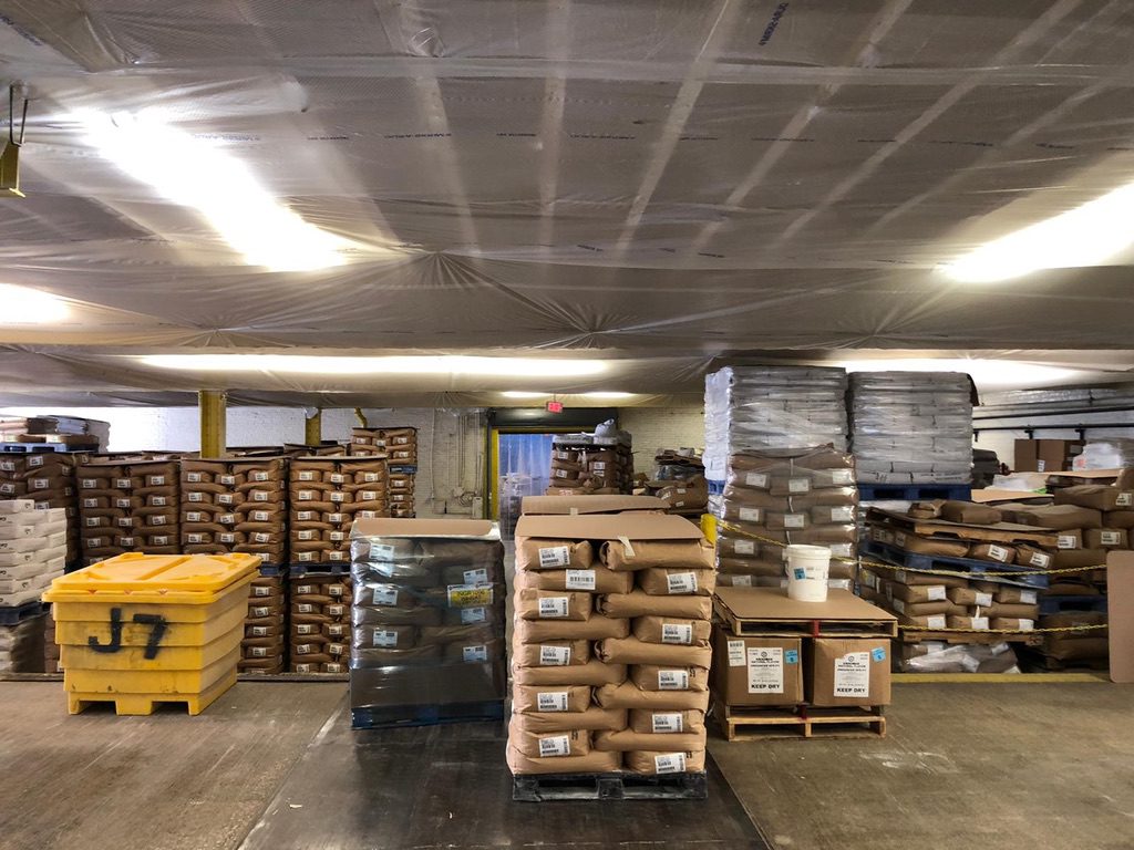 A warehouse filled with boxes and pallets of food.